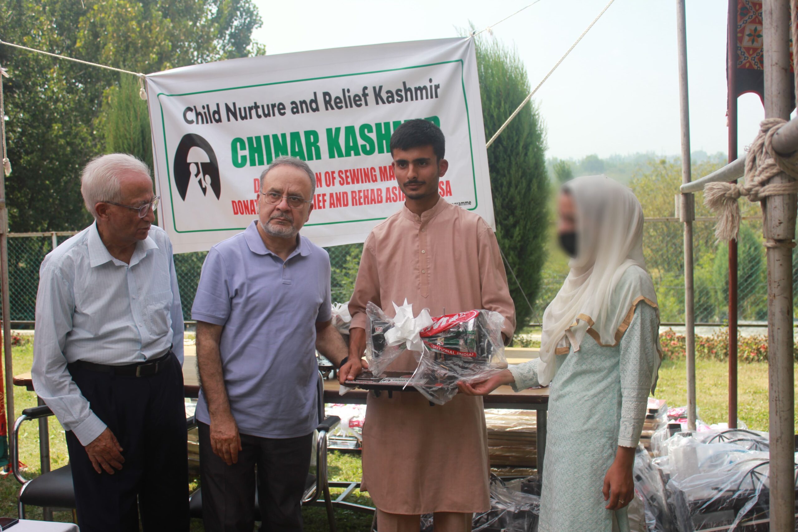 CHINAR Kashmir's president, Mr. Nazir Ahmed Qureshi along with Mr. Rass Masood Shayik, head of Relief and Rehabilitation Asia Incorporation providing free sewing machines at CHINAR Kashmir Home in Khanpora Budgam